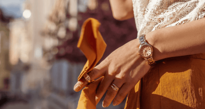 ผู้หญิงในชุดเดรสสวยงาม สวมใส่นาฬิกาเรียบหรูที่เพิ่มความสง่างามให้ลุค