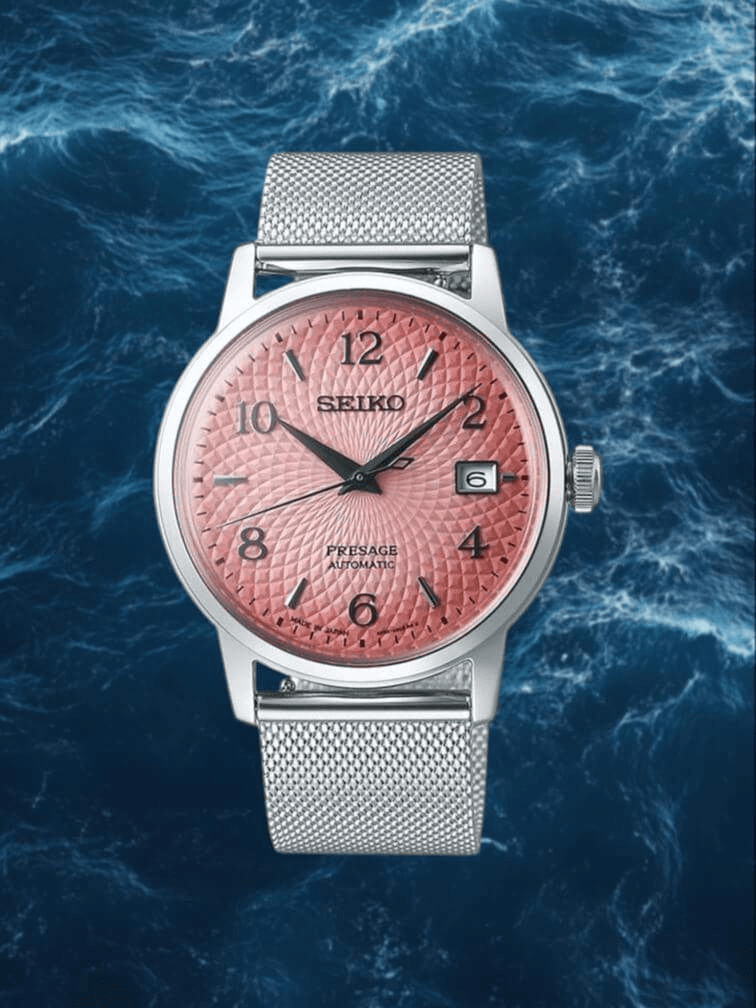 รุ่นตัวเรือนสเตนเลสสีเงิน หน้าปัดสีชมพูเข้ม พร้อมเข็มสีดำและการแสดงผลวันที่