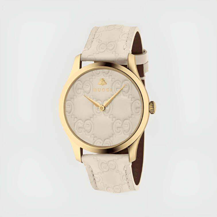 นาฬิกาสีขาวทั้งหมดพร้อมเคสทองและลายผึ้งที่โดดเด่นในดีไซน์หรูหรา